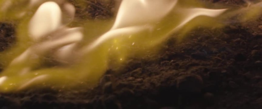 Fire spreads along the floor of a cave
