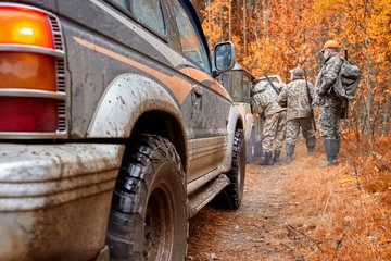 Hunter in camouflage clothes with hunting rifle. Hunting in the forest © gsshot