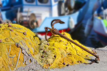 Traditional fishing nets and rusty anchor