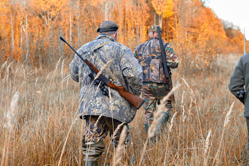 group of hunters during hunting in forest