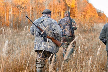 Fotobehang group of hunters during hunting in forest © gsshot