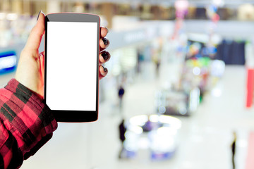 Female / woman / girl with mockup smartphone in hand in shopping mall