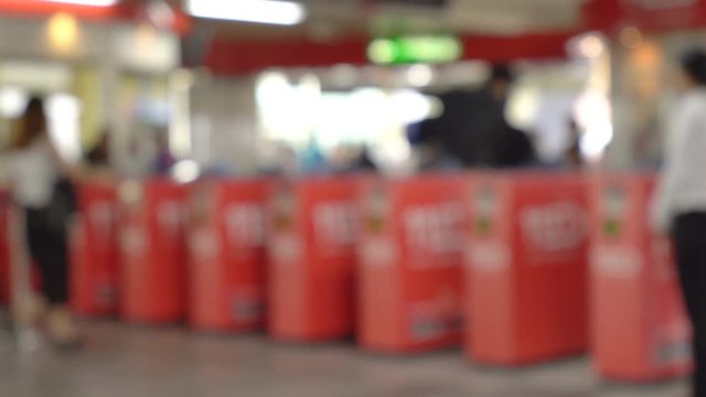 Closeup and Blurred of the crowd walking pass the ticket barrier of BTS