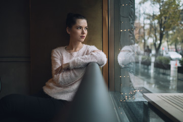 Girl sadly thoughts and looks at window