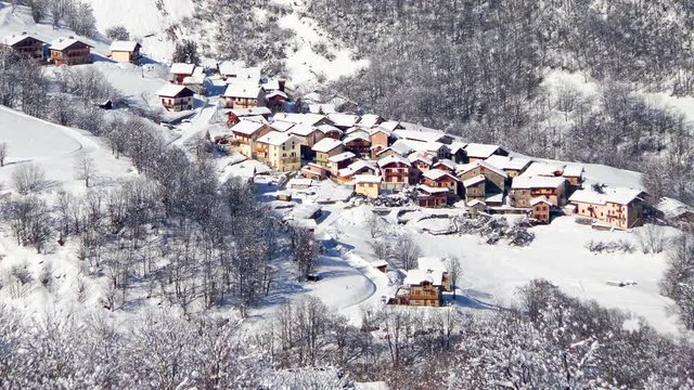 Seamless loop - Snow falling on the village of Saint Martin de Belleville in winter, the Alps, France, video HD