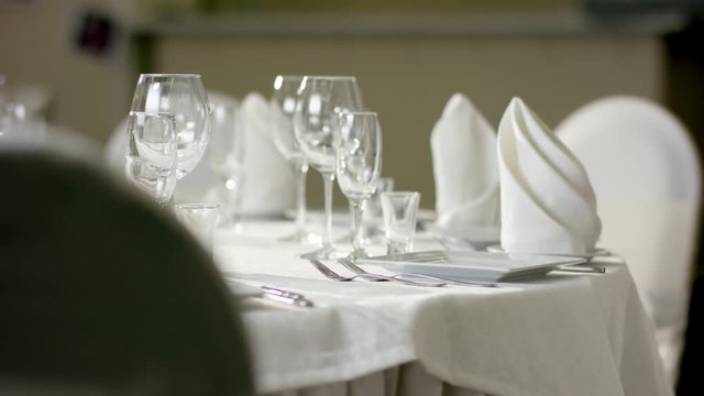 View of waiter correcting the cutlery on the banquet table at restaurant
