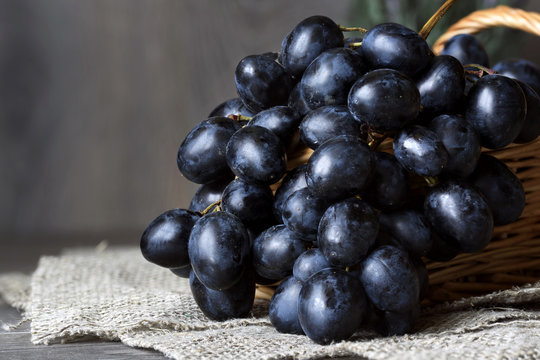 Grapes in a basket on a table on a neutral background.