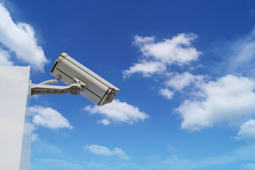 closed circuit camera on top of building  on blue sky and white cloud  background .