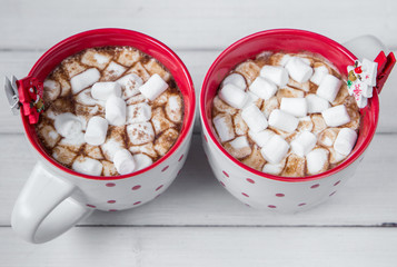 Christmas hot chocolate with marshmellow on light wooden background