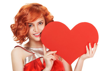 Portrait of smiling red hair woman holding big red heart. Isolated on white.