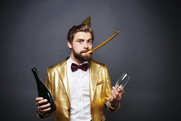 Portrait of man holding bottle of champagne and champagne glass