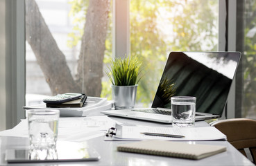 office table with business tools, desktop glass and work paper.