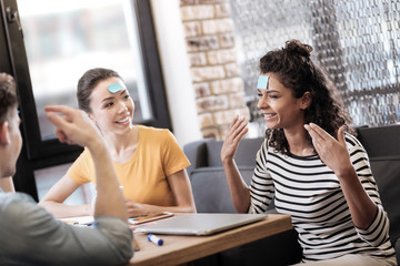 Happy girls sitting and playing a game