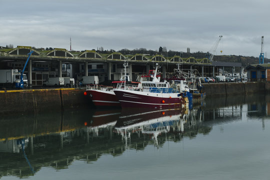 Fishing boats in a harbor. Trawler after fishing. Fishing industry, fishery. Commercial ship for seafoods in Dieppe, Normandy