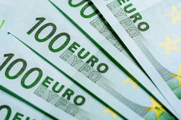 Heap of One hundred Euro currency banknotes.