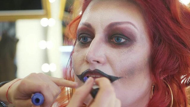 Process applying halloween makeup on face the woman in nurse style