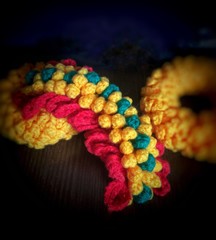 Close up middle Garland Flower Crochet ,Thailand call “Sheek Rud Malai” on blur black background