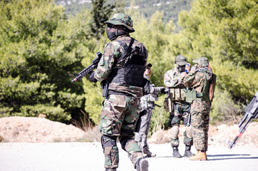 Soldier walk in forest road airsoft game