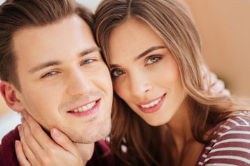 Close up of young couple beaming into camera