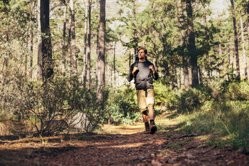 Fototapeta na wymiar Man walking in forest wearing a backpack