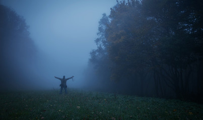 Obraz na płótnie Canvas Tourist man in the nature a foggy day