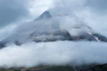 view of the gloomy peak of an extinct volcano, enveloped in fog and mystery