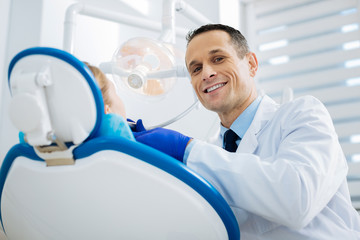 Fototapeta premium Happy experienced doctor enjoying his job