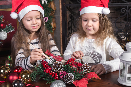 beautiful girls decorating christmas toys