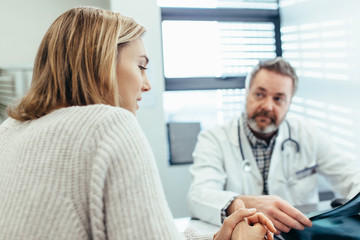 Patient talking with doctor during a consultation in clinic