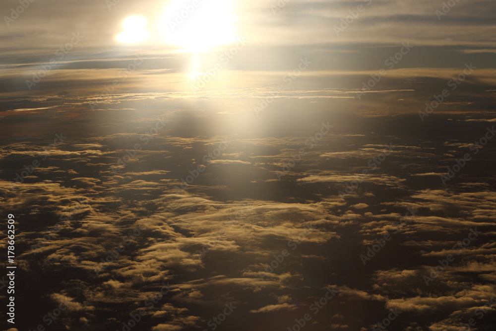 Wall mural sunset white cloud sky at high level attitude, view from window airplane