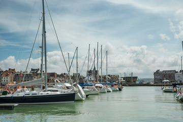 Fototapeta premium Yachts moored at quay port of Dieppe, France. Concepts of success, leisure, holiday, rich, tourism, luxury, lifestyle. Sunny Summer, blue sky. Toned