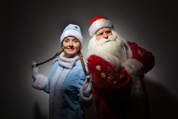 Fototapeta premium Santa Claus and Snow Maiden on a dark background.