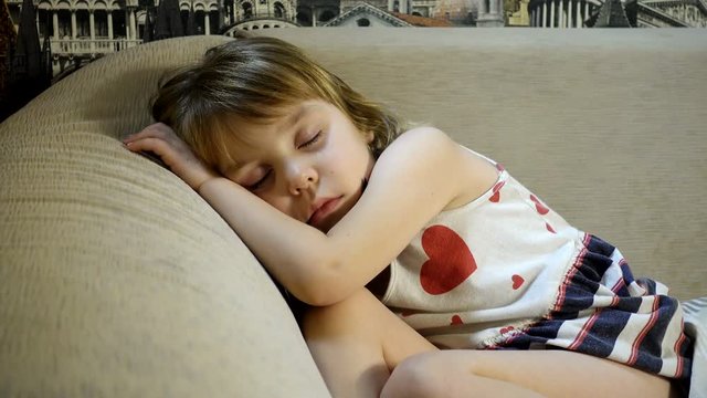 4K footage. Sleeping baby. A girl 4-5 years old in a dress fell asleep without undressing.