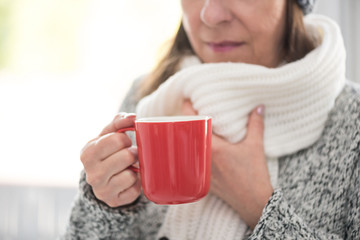 Mature woman drinking hot beverage