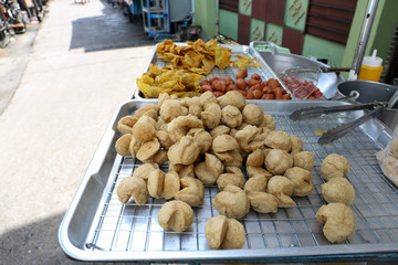 Fried fish ball on the metal plate for sell at Nang Loeng market, Bangkok, Thailand