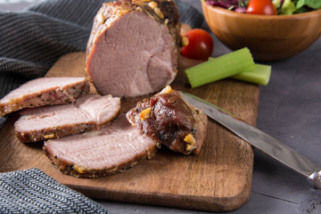 Delicious spicy meat. Spicy meat baked with chili pepper. Piece of baked meat with spices and vegetables on the table. Spicy baked meat prepared for eat.