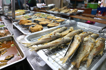 Fried salted fish and various Thai style food for sell at Nang Loeng market, Bangkok, Thailand