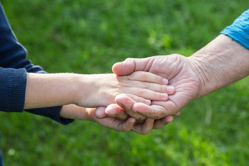 hand of a boy in the hand of a grandmother close-up