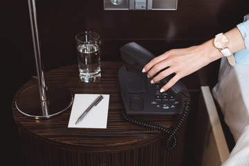 businesswoman talking by phone in hotel