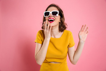 Portrait of a happy young woman in sunglasses