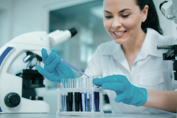Fototapeta premium Careful lab assistant mixing reagents