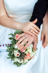 Obraz na płótnie Canvas Bride hands with ring and wedding bouquet of flowers