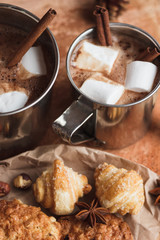 Metal cups with cacao and marshmallows