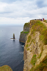Fototapeta na wymiar Cliffs of Moher, west coast of Ireland, County Clare on wild Atlantic ocean. Photo of a beautiful scenic sea and sky landscape. View of ocean scenery, vertical