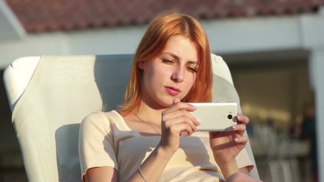 girl takes pictures on a smartphone, slow motion