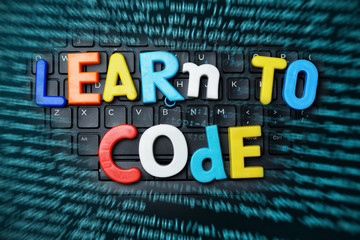 Education technology concept with learn to code advice from colorful letters on notebook keyboard