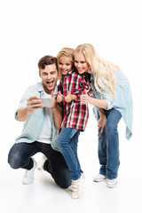 Full length portrait of a pretty family with a child