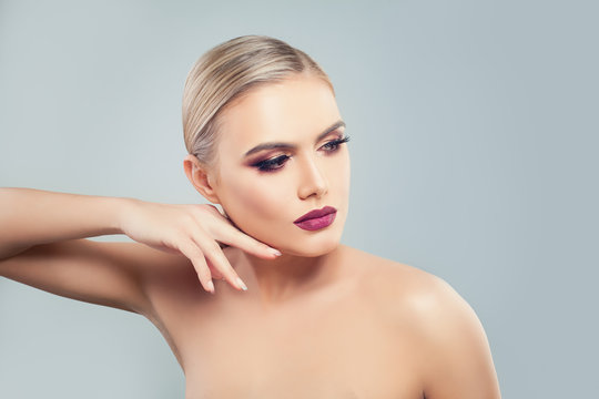 Beautiful Model Woman with Healthy Skin on Blue Background. Beauty, Facial Treatment and Cosmetology