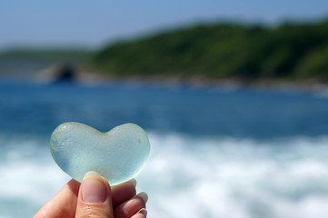 glass heart on sea background