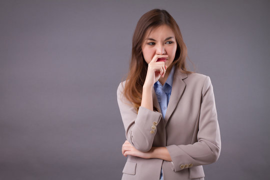 frowning upset woman suffering from stinking bad smell